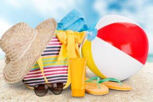 straw hat, bag, flip flops on a